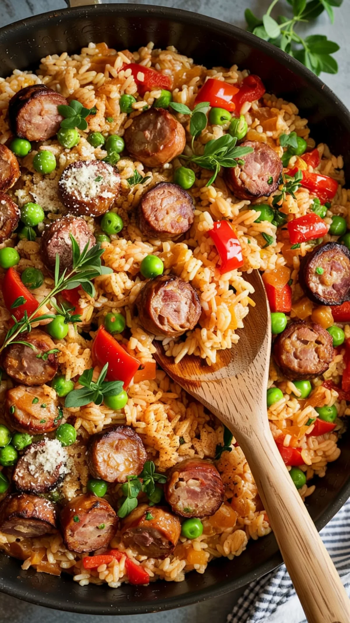 Steaming skillet of Italian sausage rice with colorful peppers, peas and Parmesan